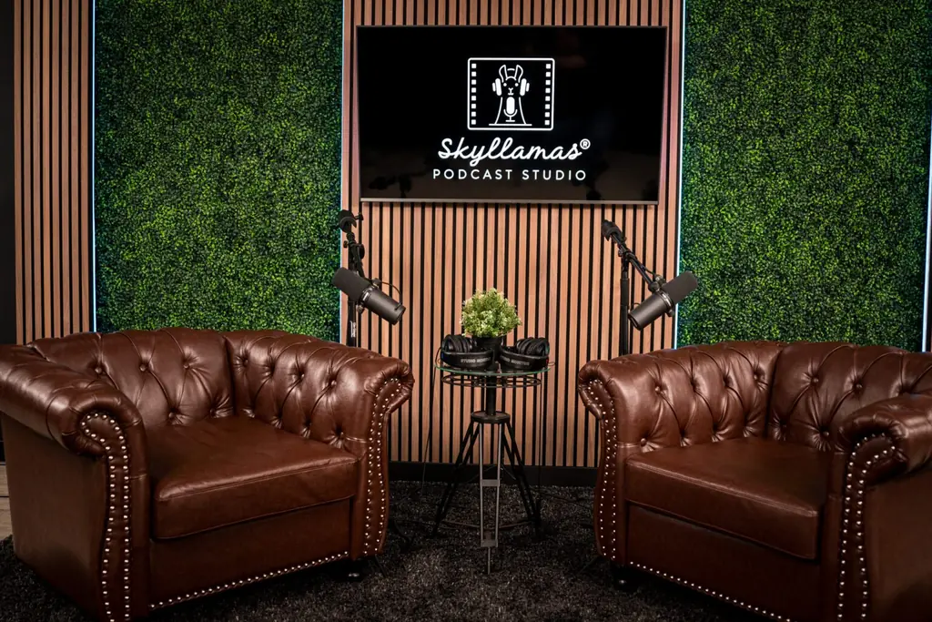 The Skyllamas couch set with two leather chairs and the studio logo